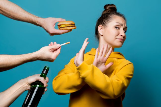girl in bright clothes refuses junk food, alcohol and cigarettes girl in bright clothes refuses junk food, alcohol and cigarettes, preferring a healthy lifestyle