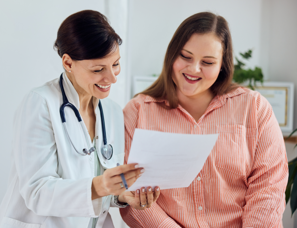 A-smiling-female-nutritionist-showing-good-progress-results-to-a-happy-overweight-patient.-1499725227_8011x5343